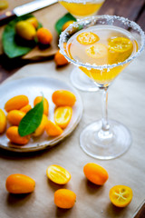 cocktail with kumquat on wooden background