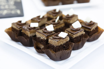 Catering Miniature chocolate meringue cakes with cream and
