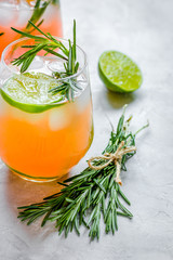 healthy morning with fresh drink, lime and rosemary on stone tab