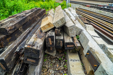 Old wooden and concrete sleepers stacked for disposal.