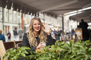 Young woman drinking cocktail in a cafe