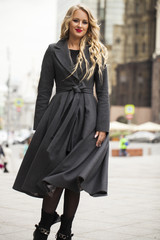 Fototapeta premium Portrait of a young beautiful woman in gray coat