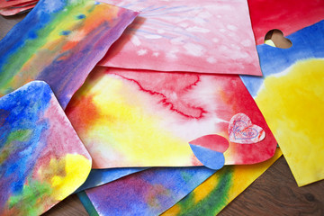 A photo of the artistic hand drawn abstract wet watercolor background, waldorf colorful template and a pencil. A lesson of drawing in Waldorf Steiner school, kindergarten. - 188693697