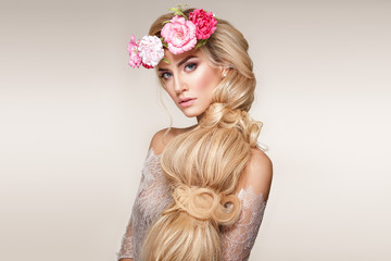 Beautiful woman portrait with long blonde hair and flowers on head. Tender bride. - 188694271