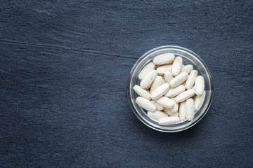 vitamin pills on dark background