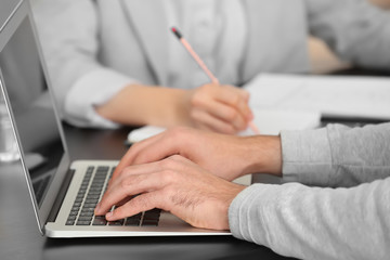 Manager working with laptop in office