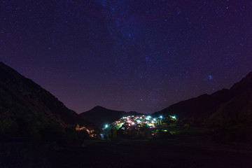 Fototapeta na wymiar Night view of mountain village, Atlas mountains, Africa. Starry night sky.
