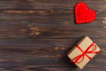 Fototapeta premium Gift box with fabric hearts on Black wooden table