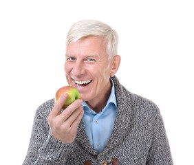 Attractive mature man with apple on white background