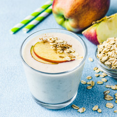 Apple pie overnight oat smoothie in glasses on light blue background. Selective focus, space for text. 
