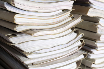 Stack of old folders with documents in archive, closeup