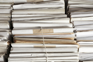 Stacks of old folders with documents in archive, closeup