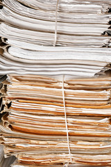 Stack of old folders with documents in archive, closeup