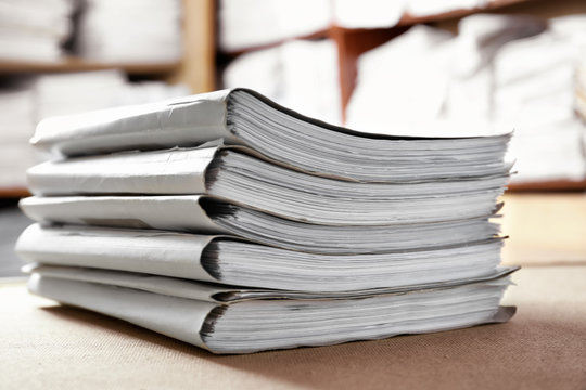 Stack of cardboard folders with documents in archive, closeup