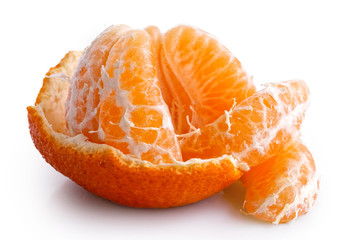 A half peeled mandarin split into segments isolated on white.