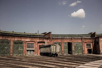 Fototapeta na wymiar Old rusty soviet wagon at abandoned railway platform. Horizontal color photography.