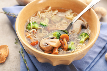 Bowl with mushroom soup on table
