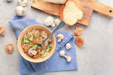 Bowl with mushroom soup on table