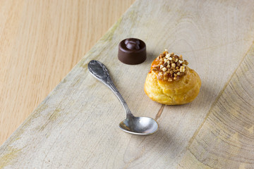 small cake with praline ans chocolate on wood