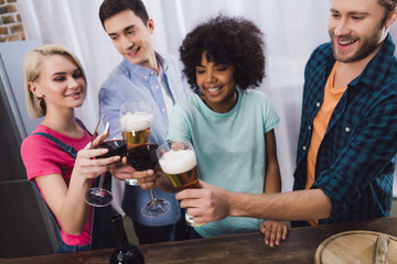 overhead view of multiethnic friends clinking with glasses of wine and beer