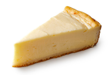 A slice of plain baked cheesecake isolated on white.