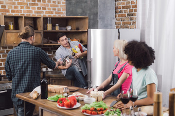 man taking sauces from fridge in kitchen
