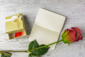 rose on a notebook and a gift with hearts