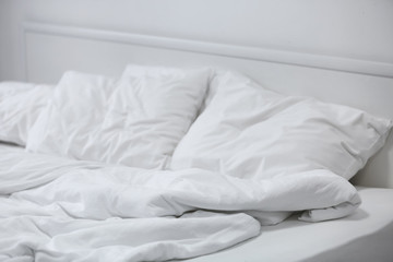 Comfortable bed with soft pillows, closeup