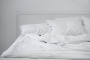 Fototapeta na wymiar Comfortable bed with soft pillows, closeup