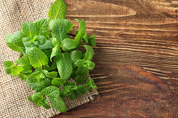 Fresh lemon balm on wooden background, top view