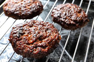 Burger patties on grill, closeup