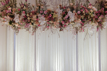 Beautiful backdrop flowers arrangement over white fabric