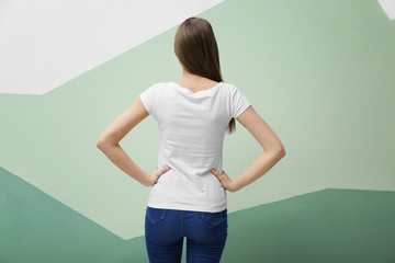 Young woman in white t-shirt on color background. Mockup for design