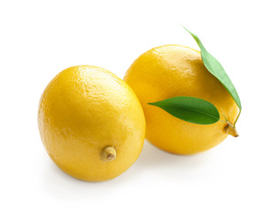 Fresh ripe lemons with leaves on white background