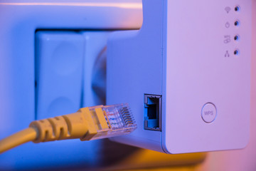 Insert ethernet cable into WiFi extender device which is in electrical socket on the wall