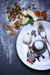 Patisserie concept. Chocolate fondant with ice cream and chocolate sauce