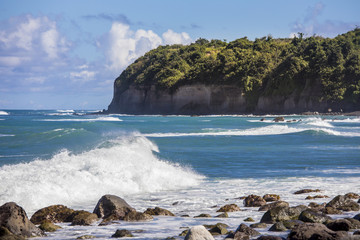 View of rocky beach and sea cliffs on St Kitts in the Caribbean sea.