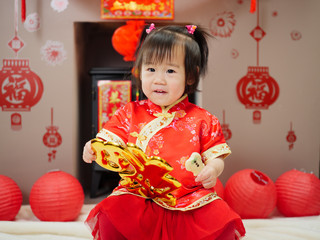 Chinese baby girl traditional dressing up hold a 