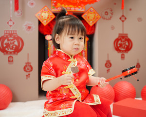 Chinese baby girl with traditional dressing up celebrate Chinese new year.some 
