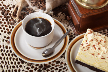 black coffee in a cup with chocolate cake