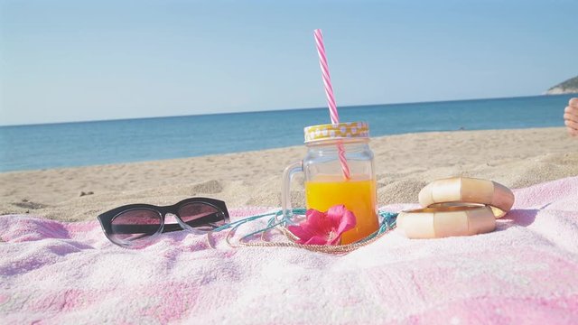 Summer time with juice and sea / ocean on the beach.