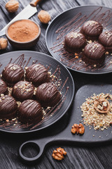 delicious mini chocolate cakes with walnut on a black wooden table