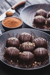 delicious mini chocolate cakes with walnut on a black wooden table