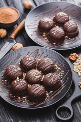 delicious mini chocolate cakes with walnut on a black wooden table