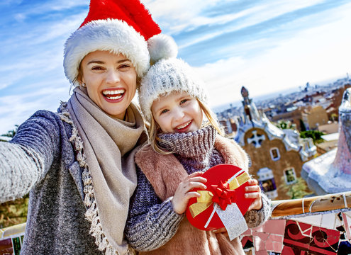 mother and daughter at Guell Park at Christmas taking selfie