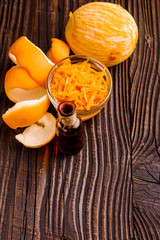 orange essential oil on a wooden background