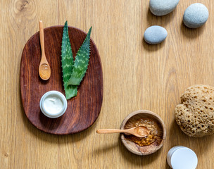 Handmade aloe vera cosmetic with zen pebbles and wooden backgroun