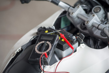 testing the battery of the motorcycle