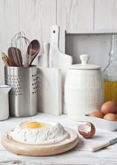 Fototapeta na wymiar Ingredients for pancakes, sweet pastries. Close-up, selective focus. White vintage wooden background.