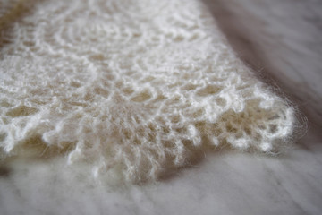 White knitted shawl close-up. Orenburg downy shawl